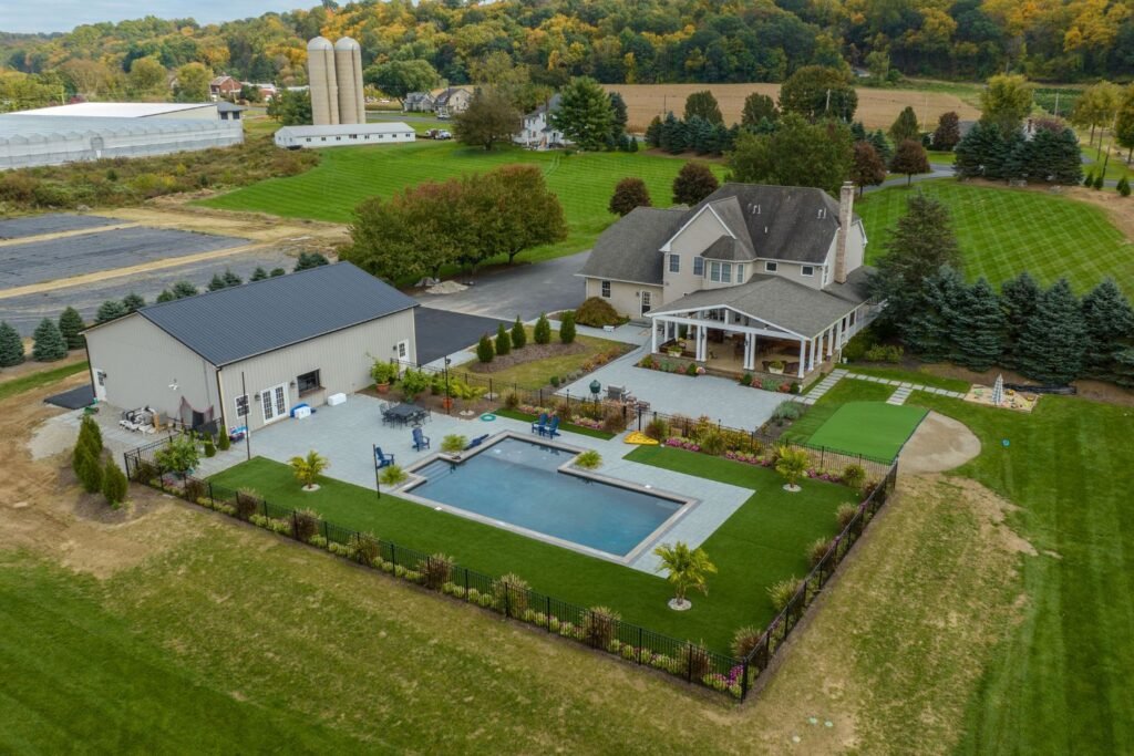 Are Barndominiums Safe: 7 Essential Safety Tips 2 Luxury estate with a barndominium-style guesthouse, pool, and outdoor living area