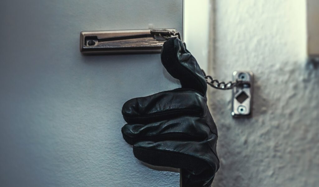 Are Barndominiums Safe: 7 Essential Safety Tips 5 A gloved hand trying to open a door secured with a chain