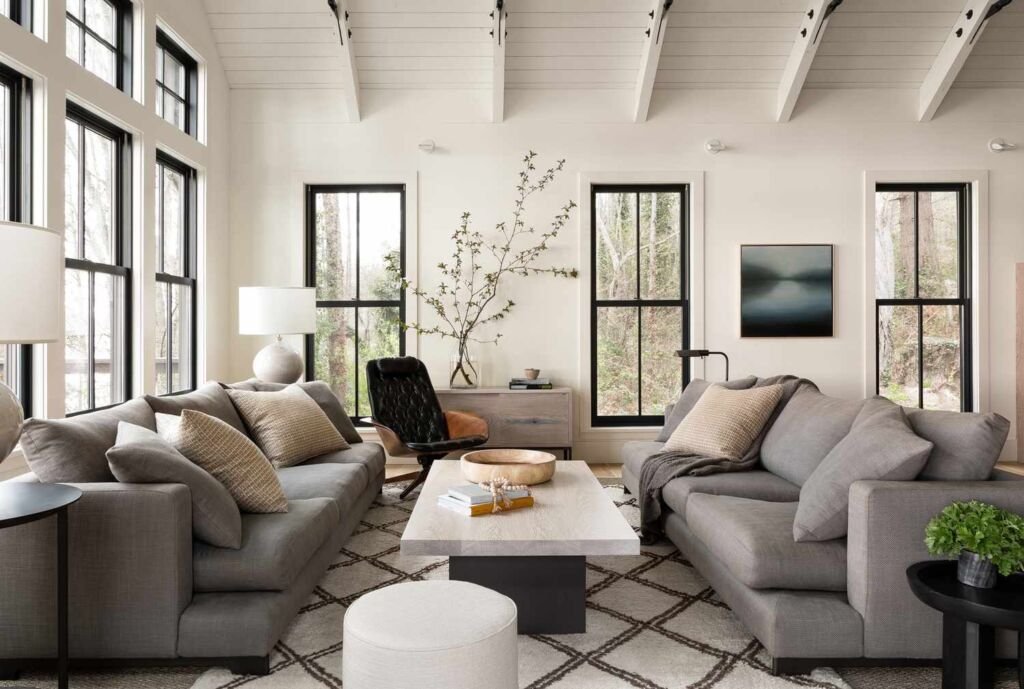 Gray modern farmhouse living room with two sofas, a coffee table, and a rug