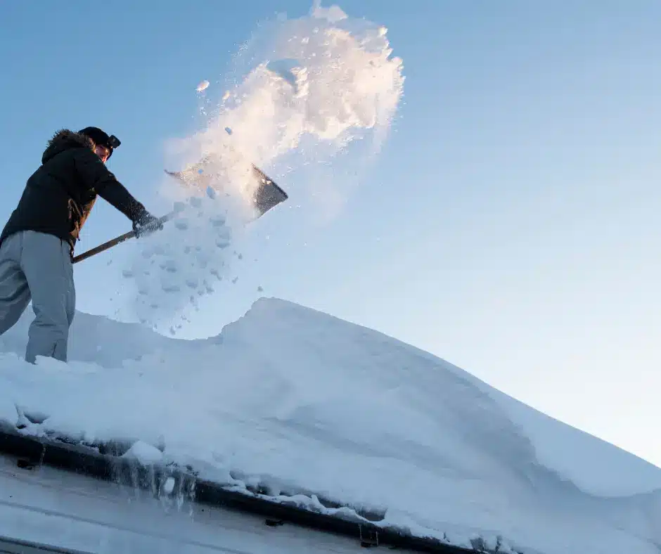 Types of Pole Barn Trusses: A Look at 7 Truss Styles 10 A man removes snow from the roof of his house