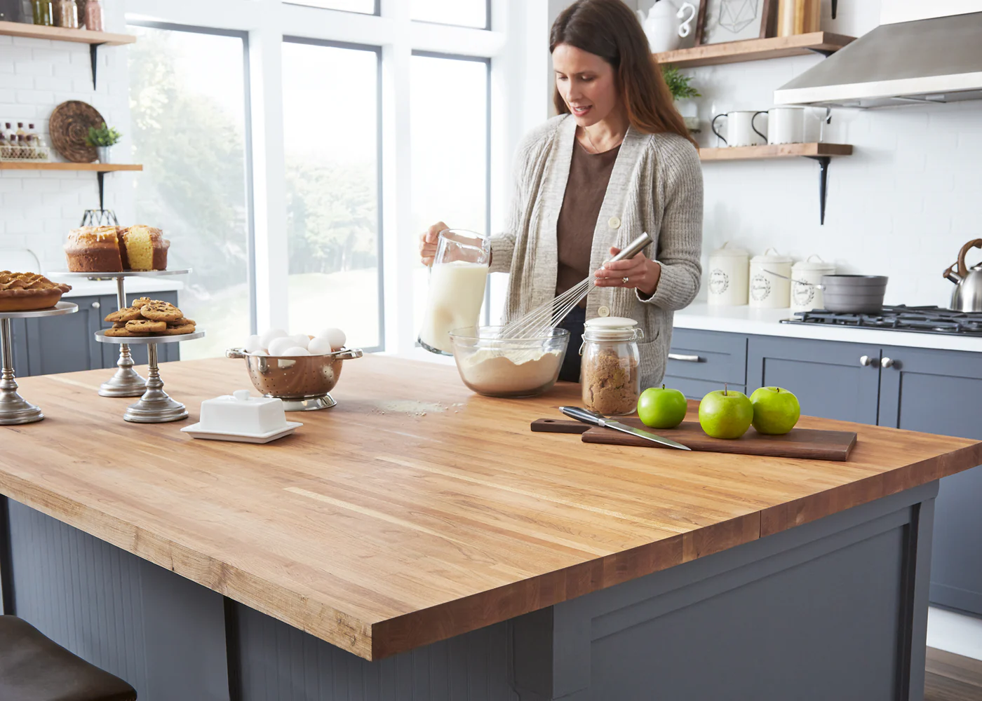a woman mixing ingredients in a Butcher Block Countertops