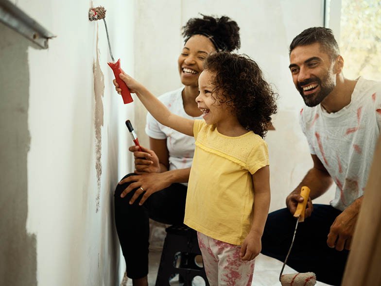 Happy family painting the house
